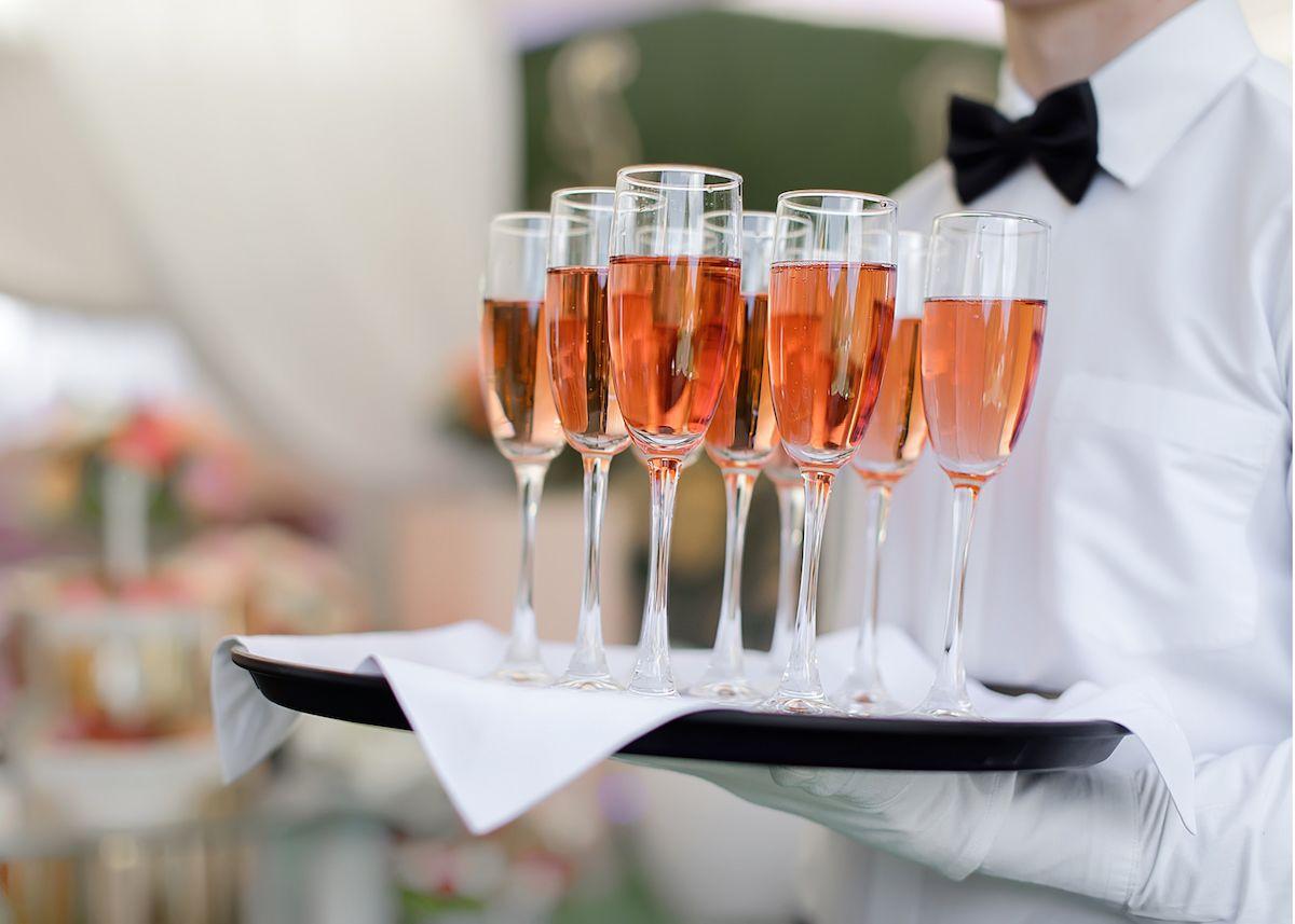 The Plaza Hotel Pioneer Park El Paso Luaran gambar A waiter holding a tray of champagne